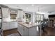 Bright, open kitchen with a center island featuring stainless steel appliances and flows into the living room at 5240 Bristlecone Pine Way, Cumming, GA 30040
