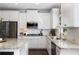 Modern kitchen featuring granite countertops, stainless steel appliances, and white cabinets at 5240 Bristlecone Pine Way, Cumming, GA 30040
