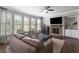 Cozy living room featuring a stone fireplace, plush seating, and hardwood floors at 5240 Bristlecone Pine Way, Cumming, GA 30040