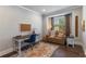 Bright office space with a lovely patterned rug, a desk, and a comfortable window-side loveseat at 5240 Bristlecone Pine Way, Cumming, GA 30040