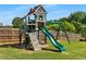 Backyard playground featuring a slide, swings, climbing wall, and lookout, providing a fun and safe play area at 5240 Bristlecone Pine Way, Cumming, GA 30040