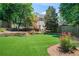 Backyard featuring artificial turf and a charming house with multi-level decks at 582 Lakeshore Ne Dr, Atlanta, GA 30307