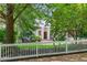 Charming white home surrounded by lush greenery and a white picket fence at 582 Lakeshore Ne Dr, Atlanta, GA 30307