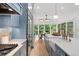 Open-concept kitchen featuring blue cabinets, marble countertops, and stainless steel appliances at 582 Lakeshore Ne Dr, Atlanta, GA 30307