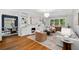 Open living room with hardwood floors, fireplace, built-ins, and view into dining area at 582 Lakeshore Ne Dr, Atlanta, GA 30307