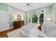 Comfortable bedroom featuring large windows, with hardwood floors and a ceiling fan at 582 Lakeshore Ne Dr, Atlanta, GA 30307