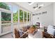 Bright sunroom features skylights, ceiling fan, comfortable seating and serene views of the wooded property at 582 Lakeshore Ne Dr, Atlanta, GA 30307
