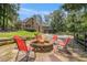 Backyard with a fire pit, outdoor seating, and a view of the house and pool at 6255 Hedgestone Way, Douglasville, GA 30135