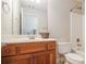 Bathroom with a wood vanity, toilet, shower, and a mirror at 6255 Hedgestone Way, Douglasville, GA 30135