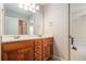 Bathroom with dual sinks, wooden cabinets, and a large mirror, open to another room at 6255 Hedgestone Way, Douglasville, GA 30135