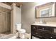 Bathroom with tiled shower, toilet, and a dark wood vanity at 6255 Hedgestone Way, Douglasville, GA 30135