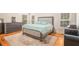 Bright bedroom featuring a comfortable bed, wooden floors, and natural light from the windows at 6255 Hedgestone Way, Douglasville, GA 30135