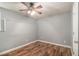 Bedroom has wood laminate flooring, a ceiling fan, and a door at 6255 Hedgestone Way, Douglasville, GA 30135
