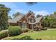 Brick home featuring a well-maintained lawn, professional landscaping, and mature shade trees at 6255 Hedgestone Way, Douglasville, GA 30135