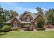Charming brick home with manicured lawn, complemented by lush trees and mature landscaping at 6255 Hedgestone Way, Douglasville, GA 30135