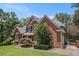 Traditional brick home with beautiful landscaping, mature trees, and inviting curb appeal at 6255 Hedgestone Way, Douglasville, GA 30135