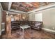 Comfortable living area showcasing a large brown sectional sofa and unique, decorative ceiling at 6255 Hedgestone Way, Douglasville, GA 30135