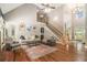 Spacious living room with hardwood floors, fireplace, and a grand staircase offers a luxurious feel at 6255 Hedgestone Way, Douglasville, GA 30135