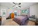 Cozy bedroom featuring a ceiling fan, carpet floors, and large window at 1468 Briarwood Ne Rd # 406, Brookhaven, GA 30319