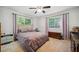 Cozy bedroom featuring natural light from two windows, neutral color, and a ceiling fan at 1468 Briarwood Ne Rd # 406, Brookhaven, GA 30319