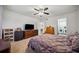Bedroom featuring a ceiling fan, carpeted floors, and views to the laundry area at 1468 Briarwood Ne Rd # 406, Brookhaven, GA 30319
