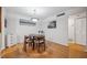 Dining area with hardwood floors, a modern light fixture, and seating for four at 1468 Briarwood Ne Rd # 406, Brookhaven, GA 30319