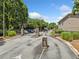 Community entrance featuring wrought iron gate, manicured bushes, and stone pillars at 1468 Briarwood Ne Rd # 406, Brookhaven, GA 30319