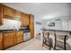 Kitchen featuring stainless steel appliances, light wood cabinets, and a breakfast bar at 1468 Briarwood Ne Rd # 406, Brookhaven, GA 30319