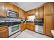 Well-equipped kitchen features stainless steel appliances and light wood cabinetry at 1468 Briarwood Ne Rd # 406, Brookhaven, GA 30319