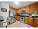 Well-lit kitchen features stainless steel appliances and wood cabinetry at 1468 Briarwood Ne Rd # 406, Brookhaven, GA 30319