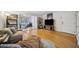 Bright living room featuring wood floors, a TV, and an adjacent office space at 1468 Briarwood Ne Rd # 406, Brookhaven, GA 30319