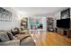 Comfortable living room with wood floors, plush seating, and an office area at 1468 Briarwood Ne Rd # 406, Brookhaven, GA 30319
