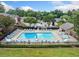 Community swimming pool with lounge chairs surrounded by mature trees at 1468 Briarwood Ne Rd # 406, Brookhaven, GA 30319