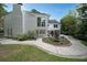 Exterior view of the home's backyard featuring a well-maintained lawn, landscaping, and outdoor seating at 167 Garden Ln, Decatur, GA 30030