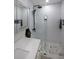 Updated bathroom features a glass-enclosed shower, marble floors, and modern fixtures at 167 Garden Ln, Decatur, GA 30030