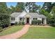 Charming home exterior with a brick walkway, well-manicured lawn, and mature landscaping at 167 Garden Ln, Decatur, GA 30030