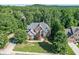 Aerial view of a beautiful brick home with mature trees at 1777 Water Springs Way, Dacula, GA 30019