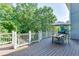 Spacious back deck with an umbrella-covered table, grill, and a view of mature trees at 1777 Water Springs Way, Dacula, GA 30019