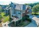 Picturesque backyard featuring a multi-level deck, lush landscaping, and an attached garage at 1777 Water Springs Way, Dacula, GA 30019