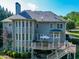 Stunning two-story home featuring a spacious deck, outdoor seating, and a beautifully landscaped yard at 1777 Water Springs Way, Dacula, GA 30019