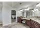 Dual vanities with granite countertops are featured in the primary bathroom adjacent to the main bedroom at 1777 Water Springs Way, Dacula, GA 30019