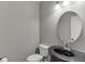 This bathroom features a toilet, modern lighting, and a dark granite sink at 1777 Water Springs Way, Dacula, GA 30019