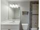 Hall bathroom features a single sink vanity, mirror with lighting, and a shower-tub combination at 1777 Water Springs Way, Dacula, GA 30019