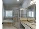 Bright bathroom features a jetted tub, glass shower, and granite countertops at 1777 Water Springs Way, Dacula, GA 30019