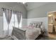 A cheerful bedroom boasts unique decor, including a gray and white color scheme and ample natural light at 1777 Water Springs Way, Dacula, GA 30019
