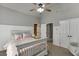 A bedroom features a wainscotting, a ceiling fan, and two closets at 1777 Water Springs Way, Dacula, GA 30019