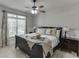 Inviting bedroom with a comfortable bed, decorative pillows, bedside tables, and a ceiling fan, creating a cozy retreat at 1777 Water Springs Way, Dacula, GA 30019