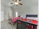 A traditional bedroom boasts gray walls, two beds and a ceiling fan at 1777 Water Springs Way, Dacula, GA 30019