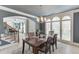 Stylish dining room featuring modern lighting, large windows, and open access to other living spaces at 1777 Water Springs Way, Dacula, GA 30019
