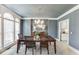 Elegant dining room with large windows, stylish chandelier, and ample natural light at 1777 Water Springs Way, Dacula, GA 30019